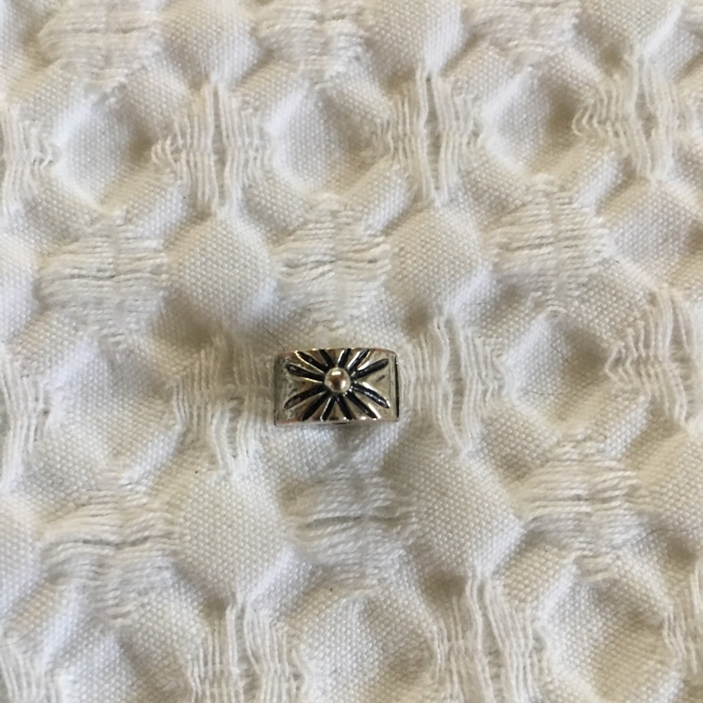 Silver starburst charm